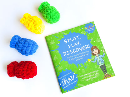 Splat, Play, Discover book with four EcoSplat Reusable Water Balloons (Red balloon, blue, yellow and green)next to it.