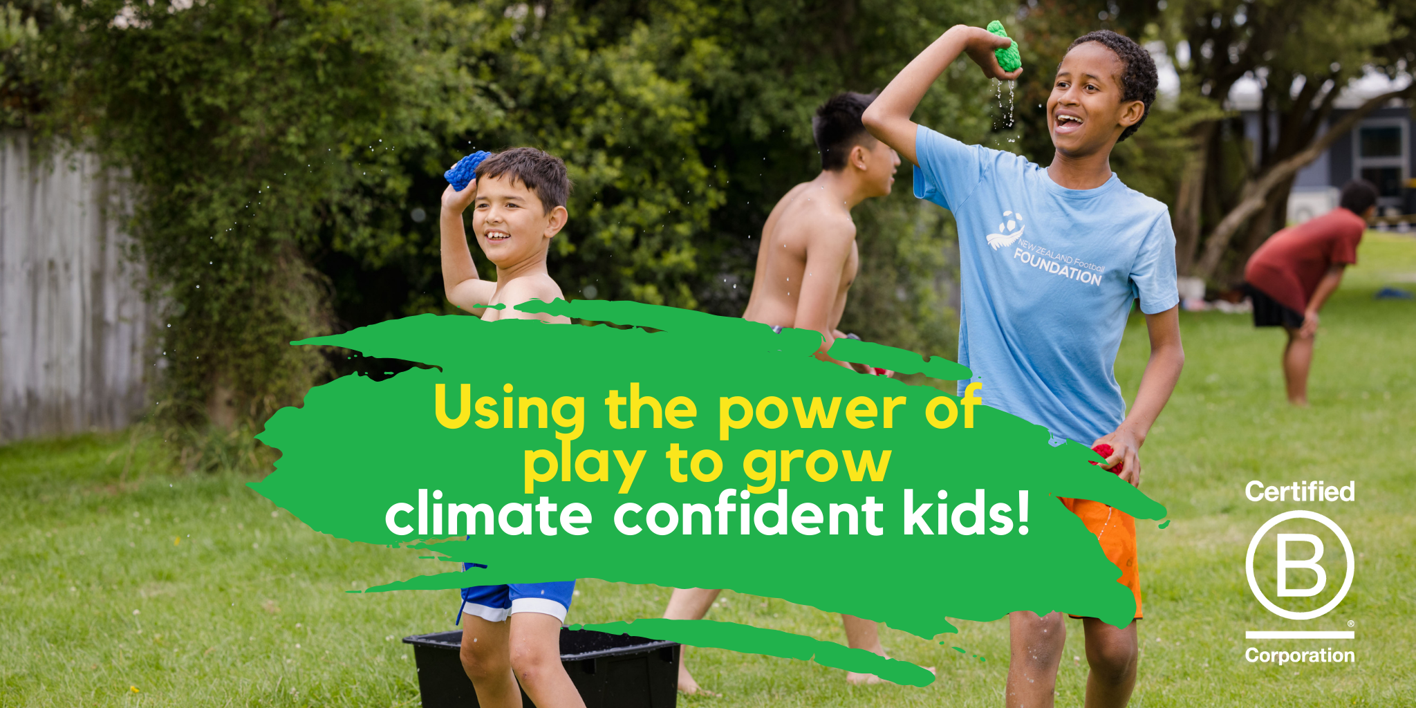 Two boys standing in a park laughing and throwing EcoSplat Reusable Water Balloons. There are two more boys in the background. Text says "Using the power of play to grow climate confident kids!" The 'Certified B Corporation" logo is in the bottom right hand corner.